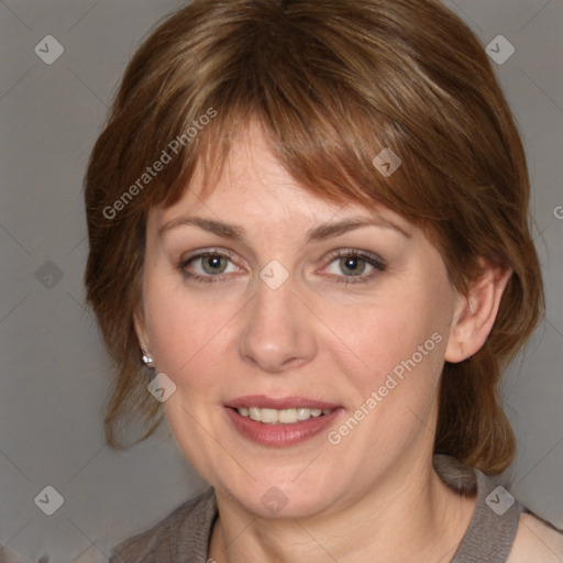 Joyful white adult female with medium  brown hair and grey eyes