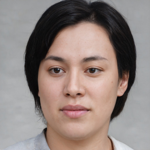 Joyful asian young-adult female with medium  black hair and brown eyes