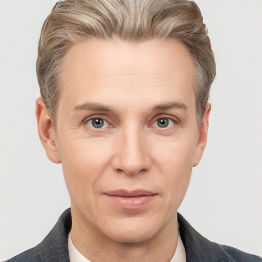 Joyful white adult male with short  brown hair and grey eyes