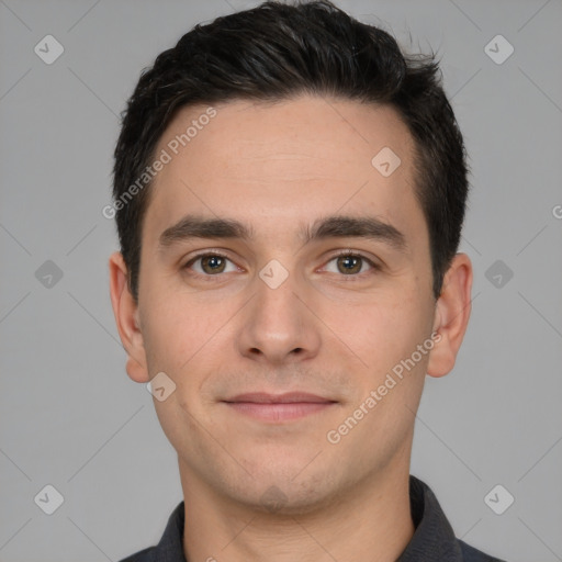 Joyful white young-adult male with short  black hair and brown eyes