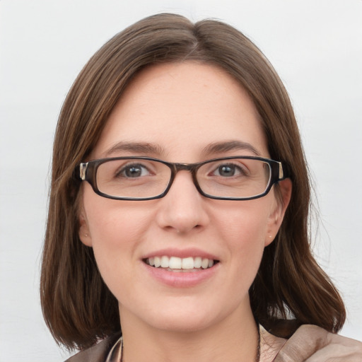 Joyful white young-adult female with medium  brown hair and blue eyes