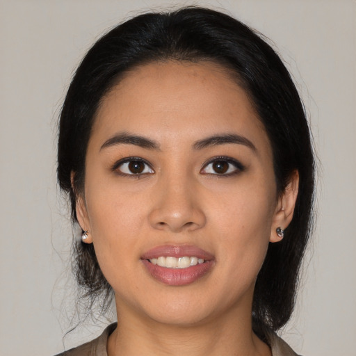 Joyful latino young-adult female with medium  black hair and brown eyes
