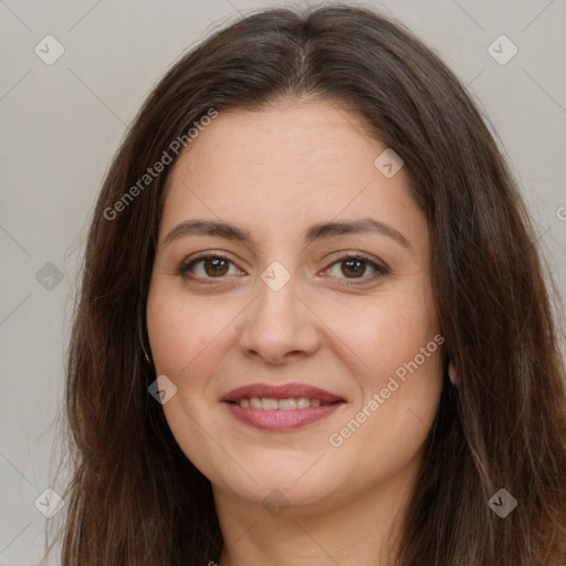 Joyful white adult female with long  brown hair and brown eyes