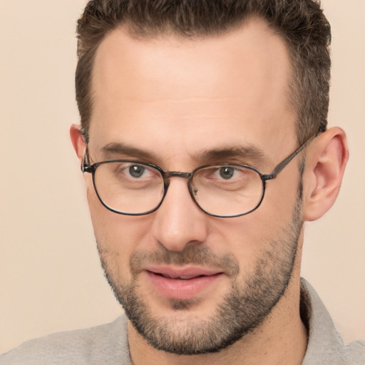 Joyful white adult male with short  brown hair and brown eyes