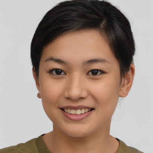 Joyful asian young-adult female with short  brown hair and brown eyes