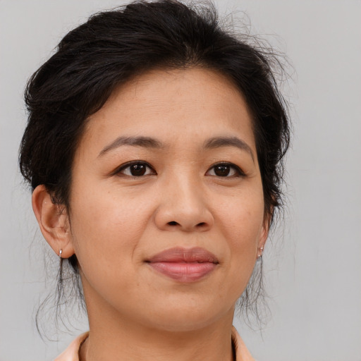 Joyful asian adult female with medium  brown hair and brown eyes