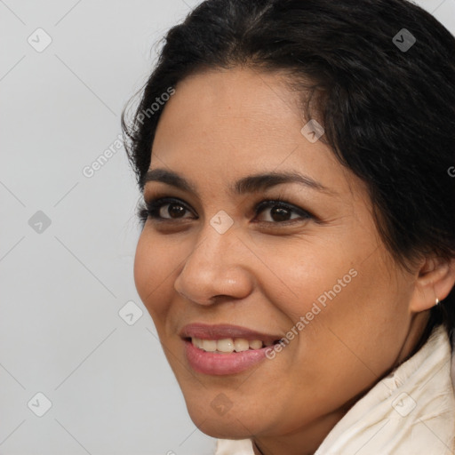 Joyful latino young-adult female with short  brown hair and brown eyes