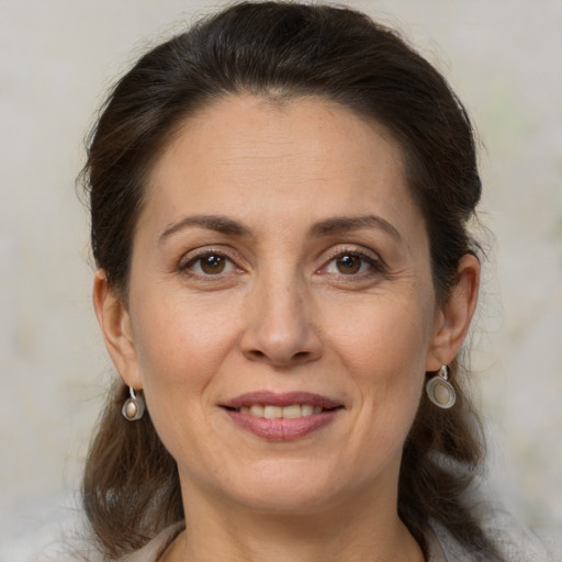 Joyful white adult female with medium  brown hair and brown eyes