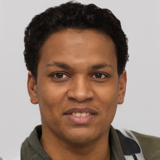 Joyful black young-adult male with short  brown hair and brown eyes