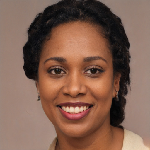 Joyful black young-adult female with long  black hair and brown eyes