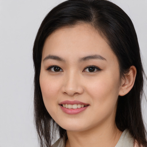 Joyful asian young-adult female with long  brown hair and brown eyes