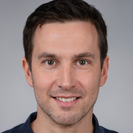 Joyful white young-adult male with short  brown hair and brown eyes