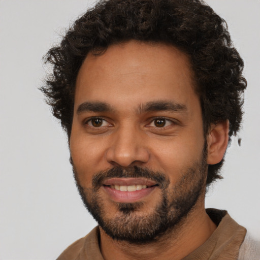 Joyful latino young-adult male with short  brown hair and brown eyes