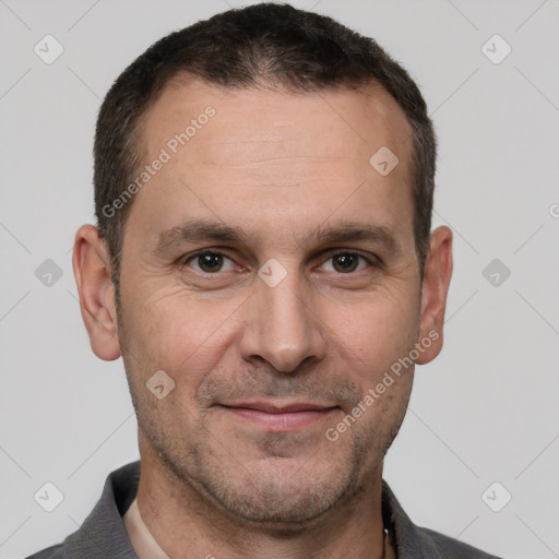 Joyful white adult male with short  brown hair and brown eyes