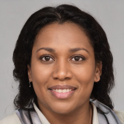 Joyful latino young-adult female with medium  brown hair and brown eyes