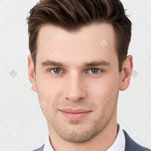 Joyful white young-adult male with short  brown hair and grey eyes