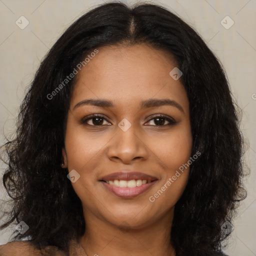 Joyful black young-adult female with long  black hair and brown eyes