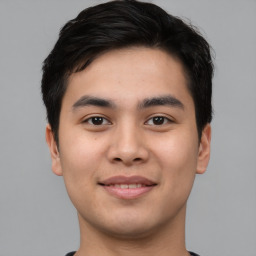 Joyful asian young-adult male with short  black hair and brown eyes