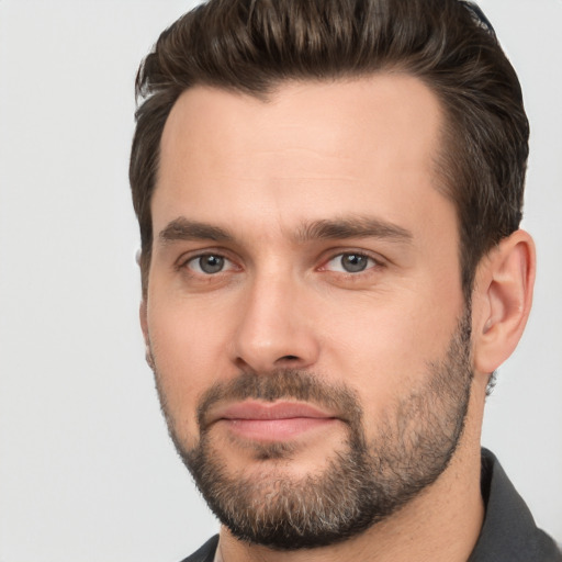 Joyful white young-adult male with short  brown hair and brown eyes