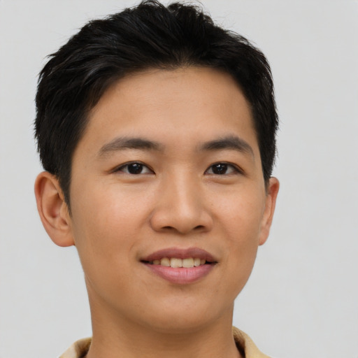 Joyful asian young-adult male with short  black hair and brown eyes