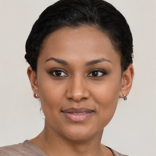Joyful latino young-adult female with short  brown hair and brown eyes