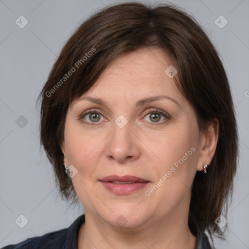 Joyful white adult female with medium  brown hair and grey eyes