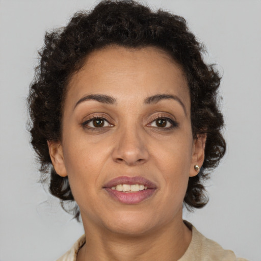 Joyful black adult female with short  brown hair and brown eyes