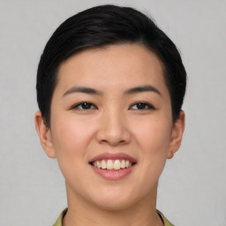 Joyful asian young-adult female with short  black hair and brown eyes