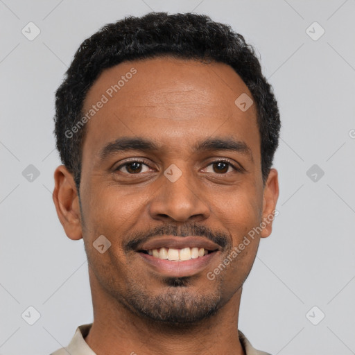 Joyful black young-adult male with short  black hair and brown eyes