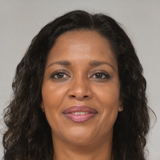 Joyful black adult female with medium  brown hair and brown eyes