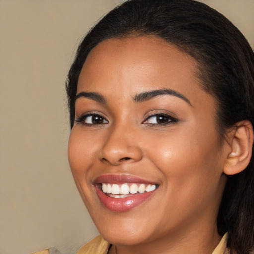 Joyful latino young-adult female with long  brown hair and brown eyes