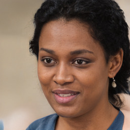 Joyful black young-adult female with long  black hair and brown eyes