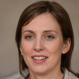 Joyful white adult female with medium  brown hair and grey eyes