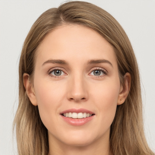 Joyful white young-adult female with long  brown hair and grey eyes