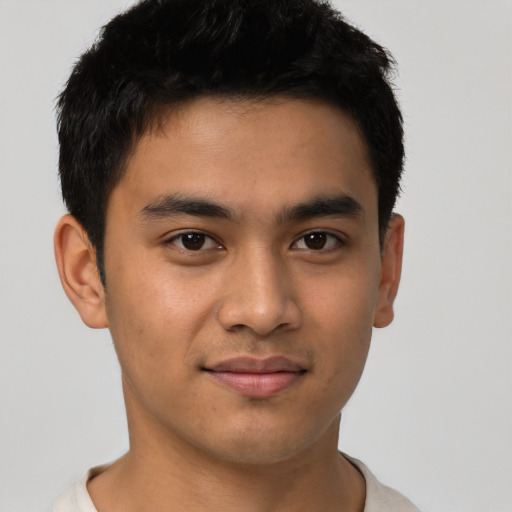 Joyful asian young-adult male with short  black hair and brown eyes