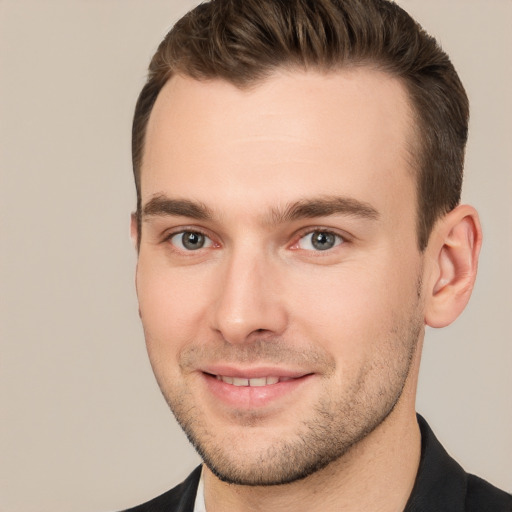 Joyful white young-adult male with short  brown hair and brown eyes