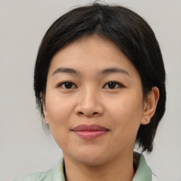 Joyful asian young-adult female with medium  brown hair and brown eyes