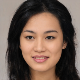 Joyful asian young-adult female with long  brown hair and brown eyes