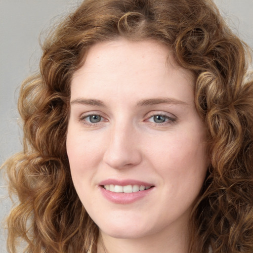 Joyful white young-adult female with long  brown hair and green eyes