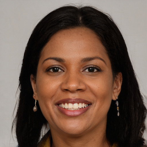 Joyful black young-adult female with long  brown hair and brown eyes