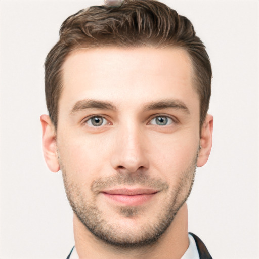 Joyful white young-adult male with short  brown hair and grey eyes