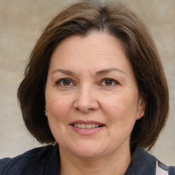 Joyful white adult female with medium  brown hair and brown eyes