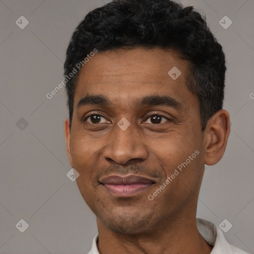 Joyful black adult male with short  black hair and brown eyes