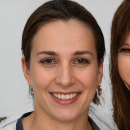 Joyful white young-adult female with medium  brown hair and brown eyes