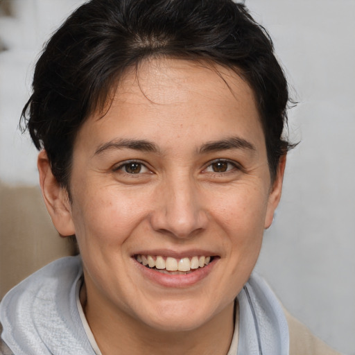 Joyful white young-adult female with medium  brown hair and brown eyes