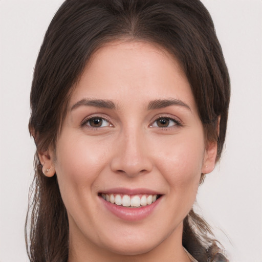 Joyful white young-adult female with medium  brown hair and brown eyes