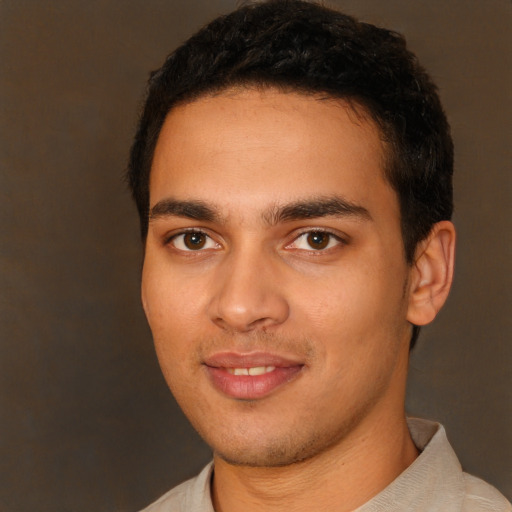 Joyful white young-adult male with short  black hair and brown eyes