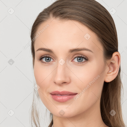 Joyful white young-adult female with long  brown hair and blue eyes