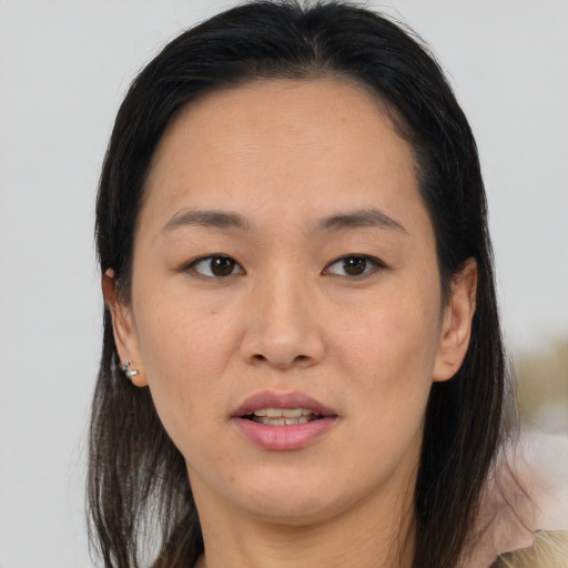 Joyful asian young-adult female with medium  brown hair and brown eyes