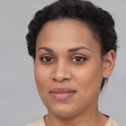 Joyful black young-adult female with short  brown hair and brown eyes